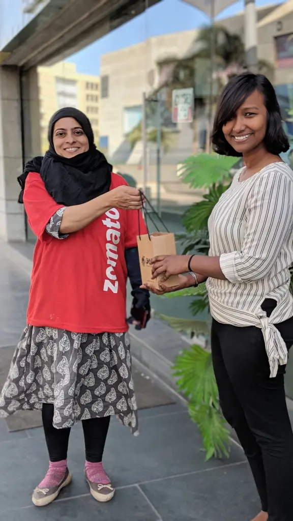 Zomato delivery partner with a happy customer