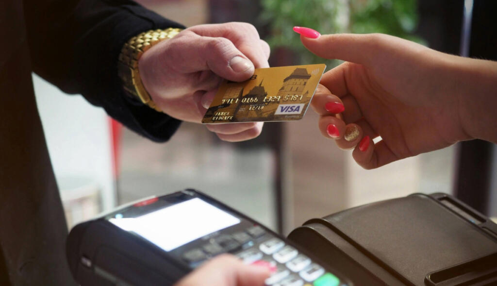 credit card getting swiped on a POS machine
