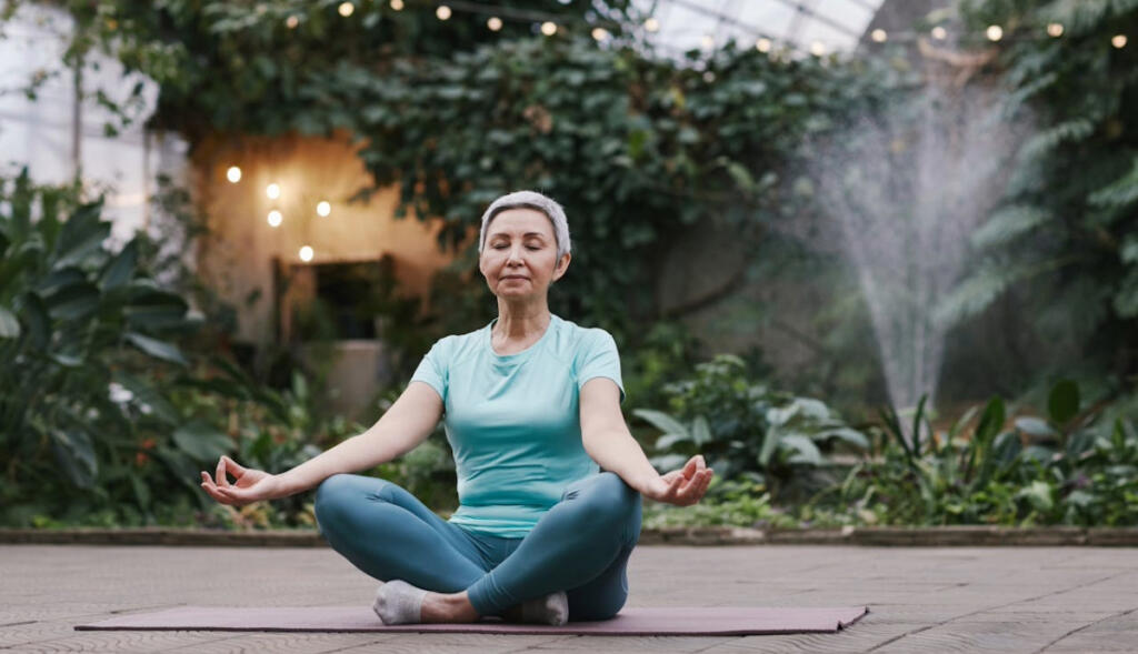 Old lady sitting in a yoga pose