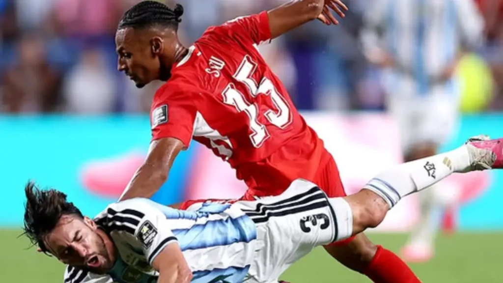 Argentina's Nicolas Tagliafico is challenged by Switzerland midfielder Djibril Sow during the Argentina vs Switzerland FIFA World Cup 2026 quarter-final.