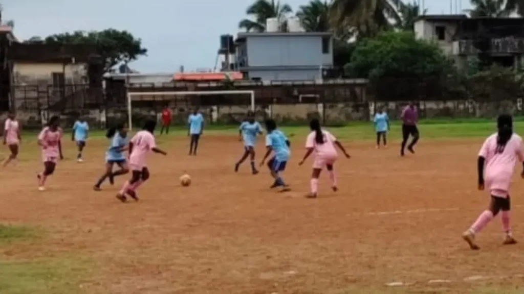 Our Lady of Perpetual Succour High School players in blue jerseys contest possession against Regina Mundi High School during the Under-17 Girls semifinal of the Subroto Mukherjee Football Tournament 2026–27 in Mormugao.