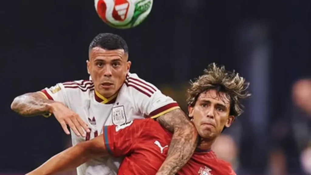 Spain midfielder Dani Olmo and Portugal forward João Félix contest an aerial ball during the Spain vs Portugal World Cup 2026 match.