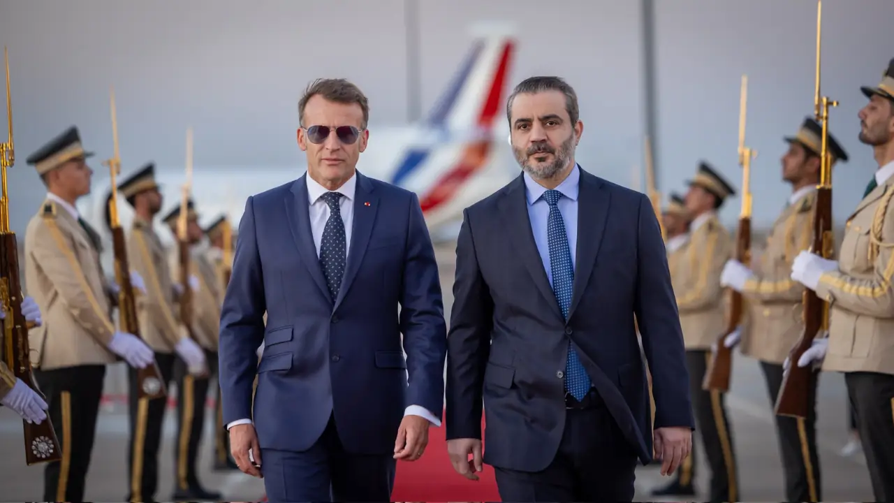 Emmanuel Macron and Ahmed al-Sharaa walk beside an honour guard during Macron’s arrival in Damascus.