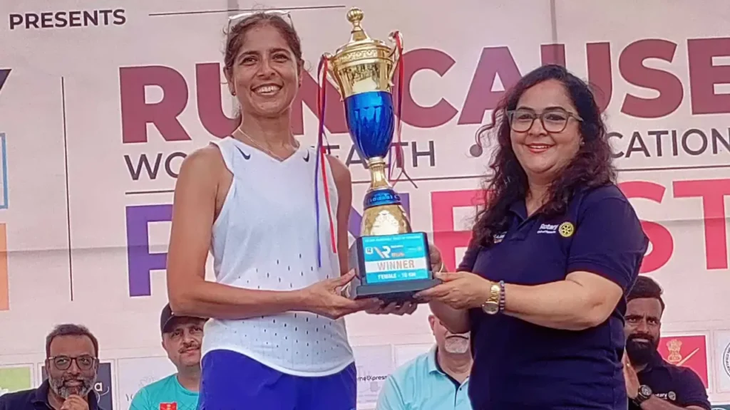 Dr Blanche Themudo accepts the women's 10km winner's trophy at the 12th Rotary Rain Run in Bambolim.