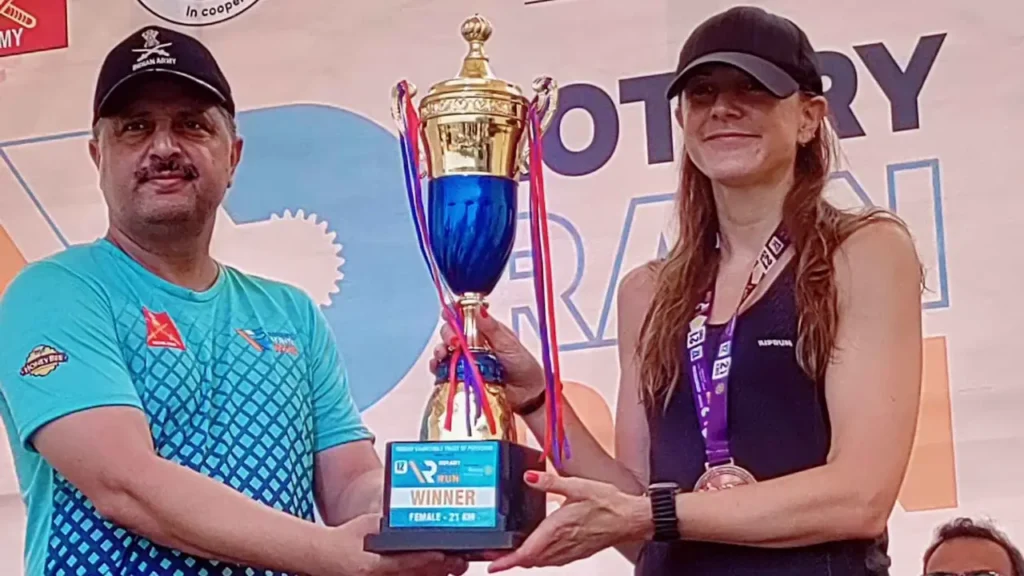Hansine Benoit poses with the women's 21km winner's trophy at the 12th Rotary Rain Run.