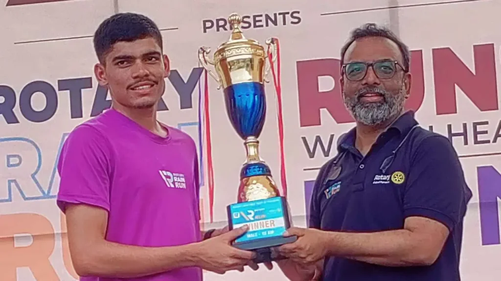 Uttam Jelugadekar receives the men's 10km winner's trophy at the Rotary Rain Run in Bambolim.