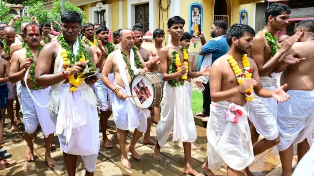 Devotees in traditional attire take part in the Chikhal Kalo festival procession at Marcel, Goa.